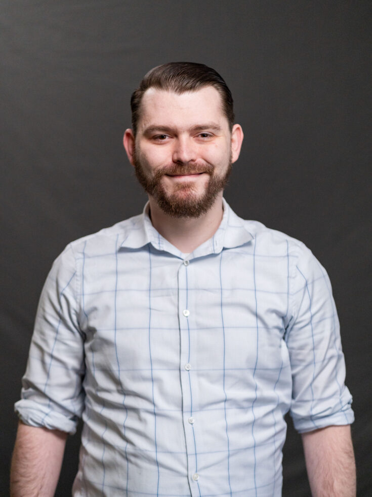 A warm, welcoming individual exudes friendliness, embodying the spirit of community and care.