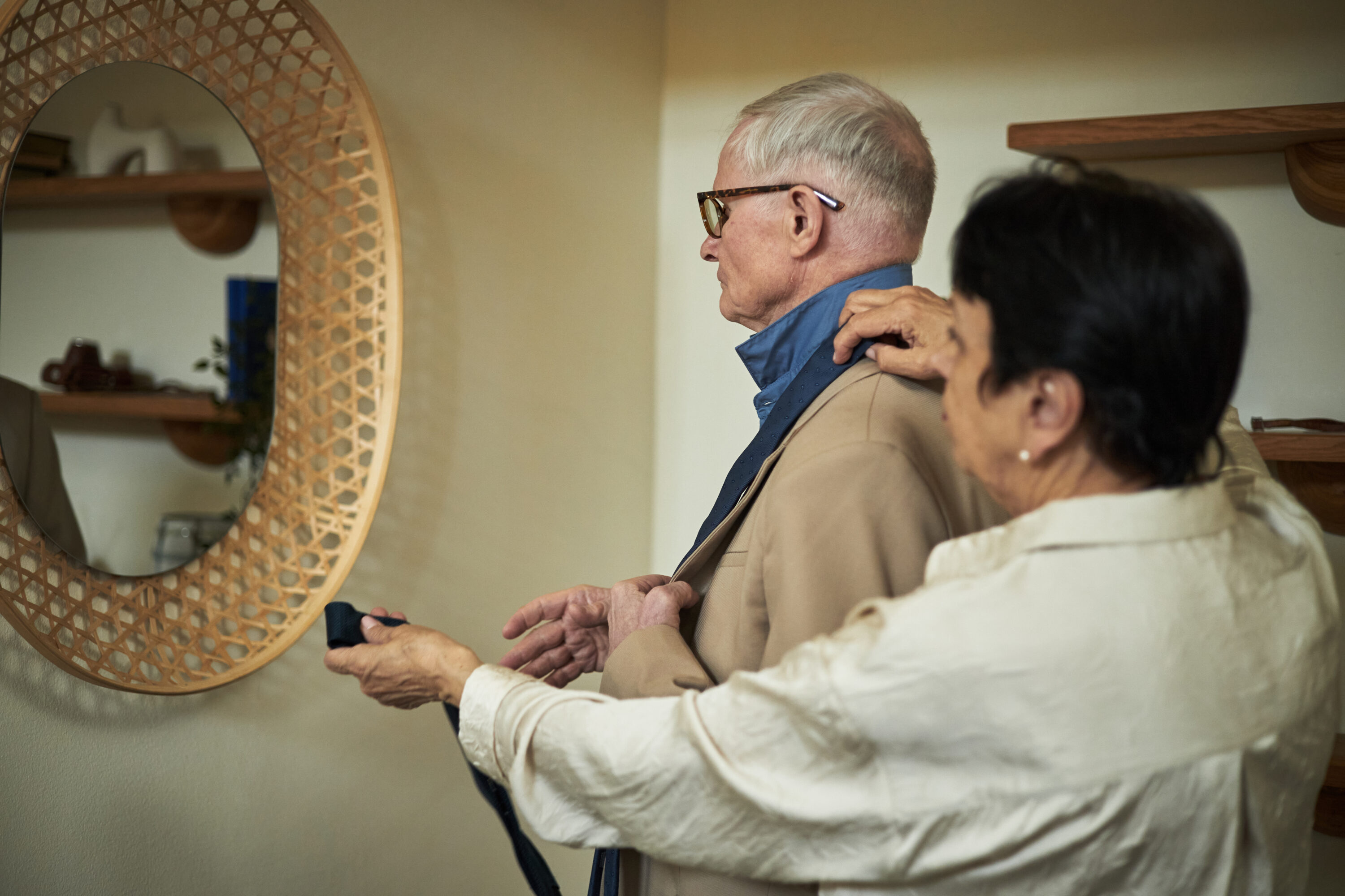Senior couple preparing together in a warm home setting, reflecting care and companionship.