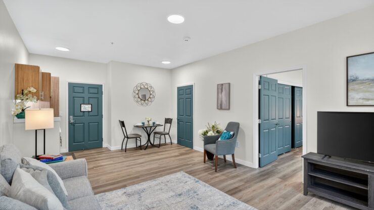 A welcoming living space with a warm atmosphere, featuring comfortable seating and inviting decor.