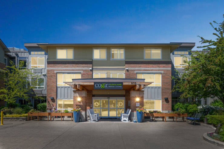 A welcoming entrance with vibrant greenery and cozy seating invites residents to connect and enjoy.