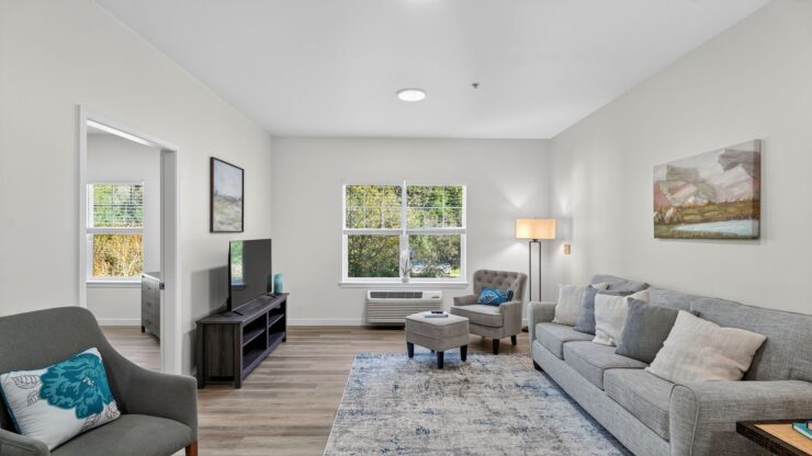 A bright, inviting living space featuring comfortable seating and warm decor, perfect for community gatherings.