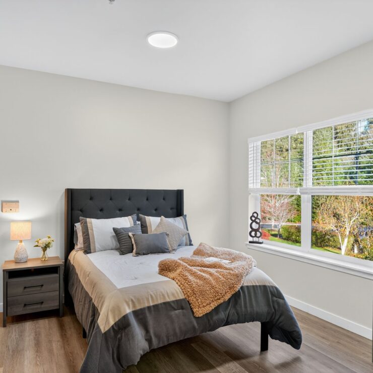 Bright and inviting, this serene bedroom offers a peaceful retreat with nature views and thoughtful decor.