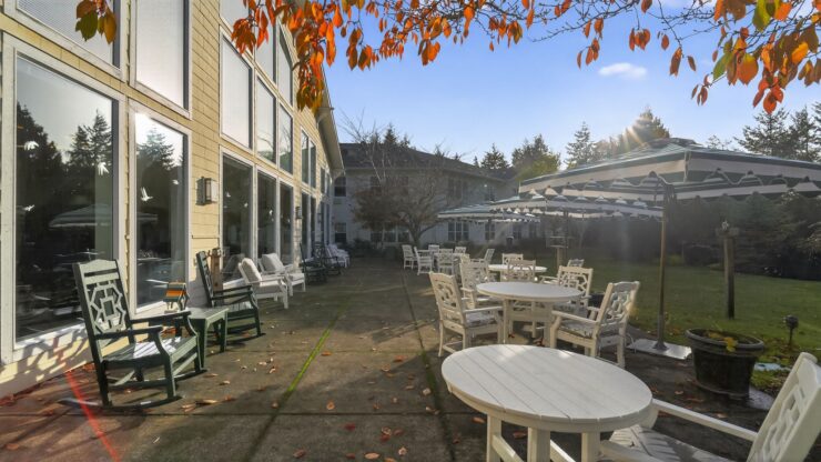 Sunny outdoor seating invites relaxation, fostering community and connection amidst a beautiful garden.