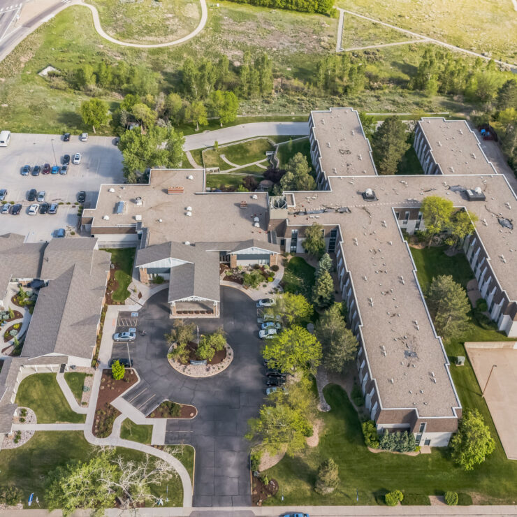 Spacious retirement community with landscaped grounds, walking paths, and ample parking.