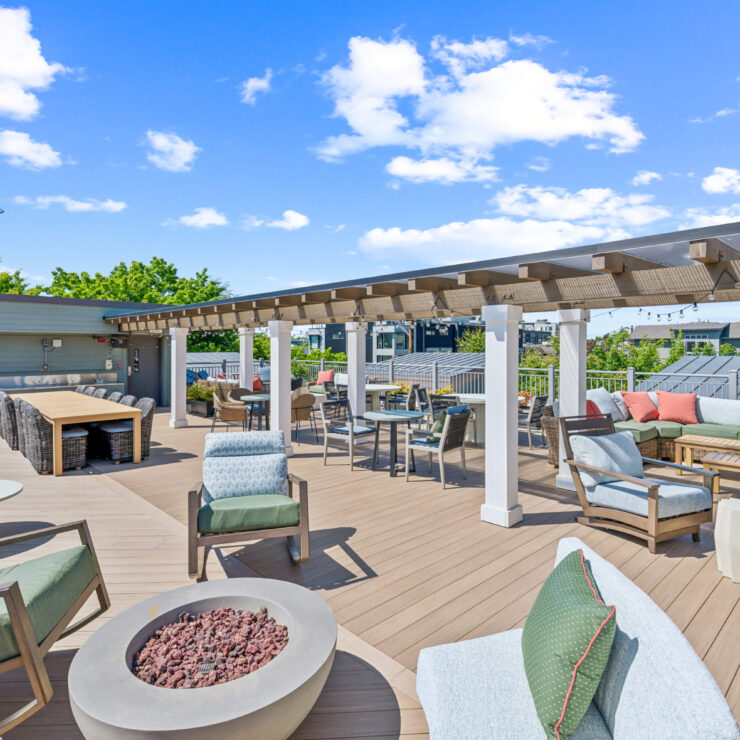 A vibrant rooftop space invites relaxation and connection, featuring stylish seating and scenic views.
