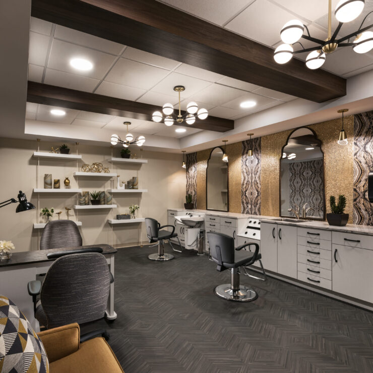 A stylish salon space featuring comfortable seating, modern decor, and a welcoming atmosphere for residents.