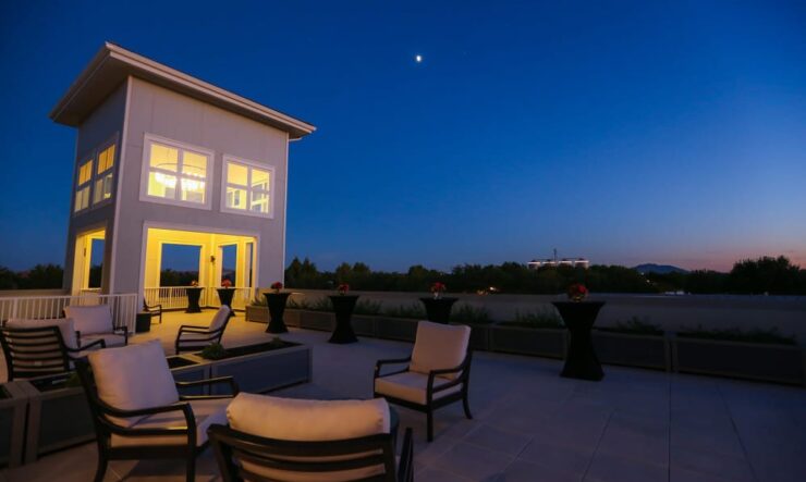 A tranquil rooftop setting invites community gatherings under the evening sky, fostering connection and comfort.