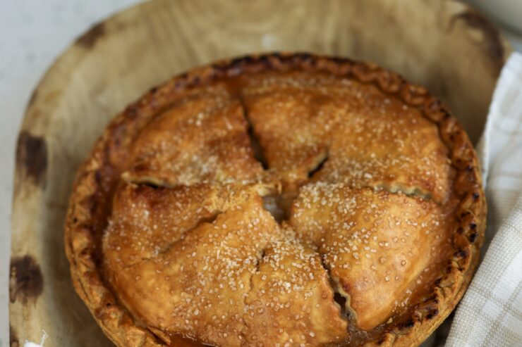 A freshly baked pie, warm and inviting, embodies the spirit of community and shared moments.