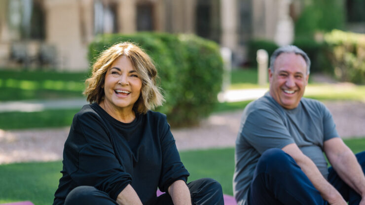 Engaged residents enjoy a joyful yoga session outdoors, fostering community and well-being.