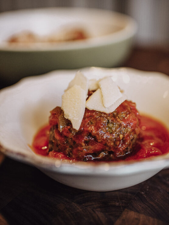 A beautifully presented meatball dish, exuding warmth and inviting community dining experiences.
