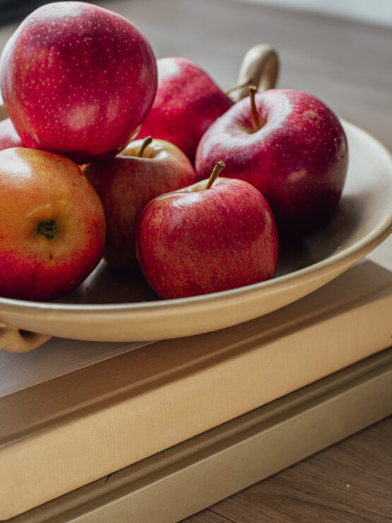A warm display of red apples on a plate, inviting a sense of community and comfort.