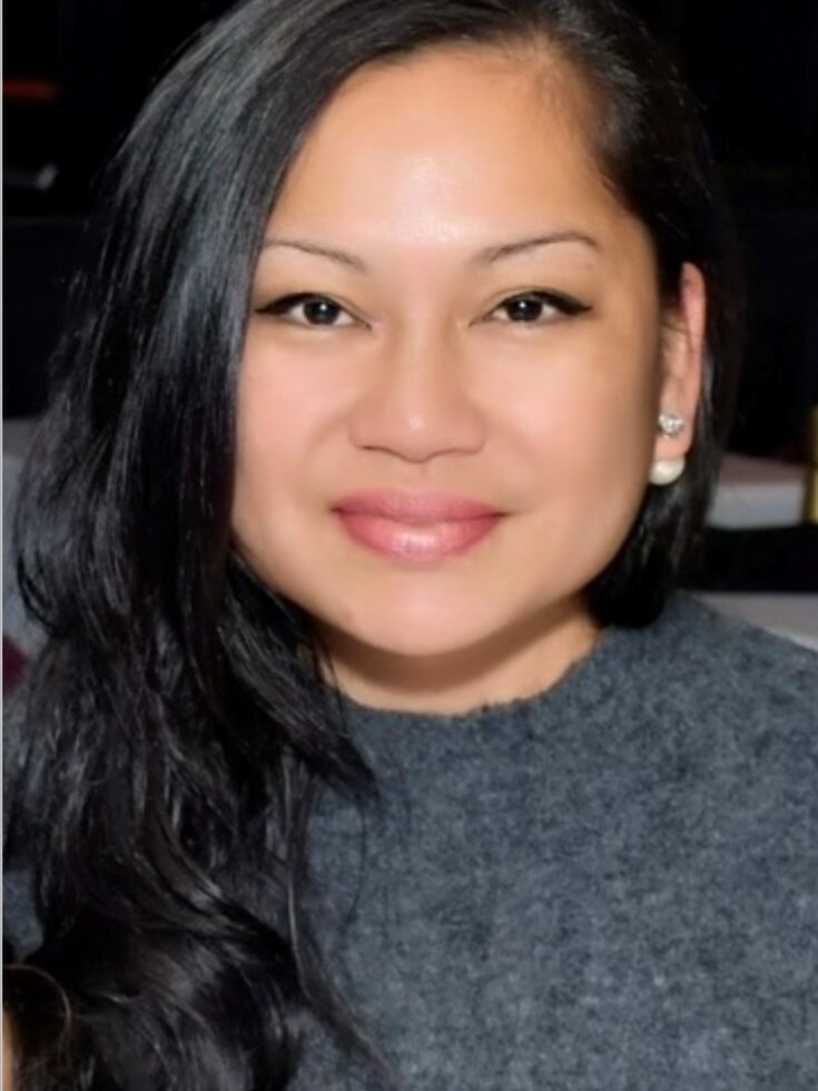 A welcoming smile reflects a supportive community atmosphere, emphasizing warmth and connection.