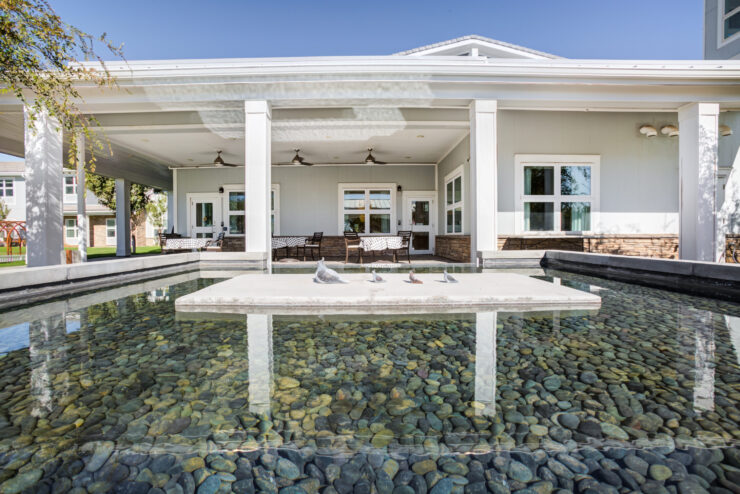 A serene outdoor space featuring a tranquil water feature, inviting seating, and a welcoming atmosphere.