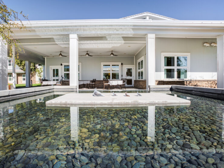 A serene outdoor space featuring a tranquil water feature, inviting seating, and a welcoming atmosphere.