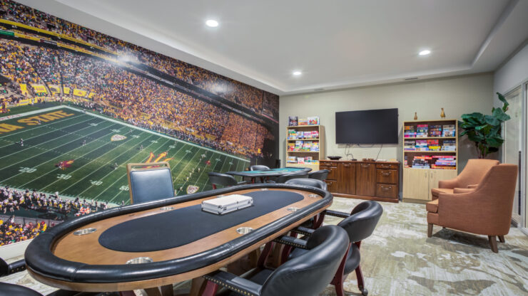 A vibrant game room invites friendly gatherings, featuring a poker table and engaging games for all.