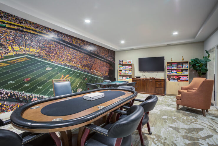 A vibrant game room invites friendly gatherings, featuring a poker table and engaging games for all.