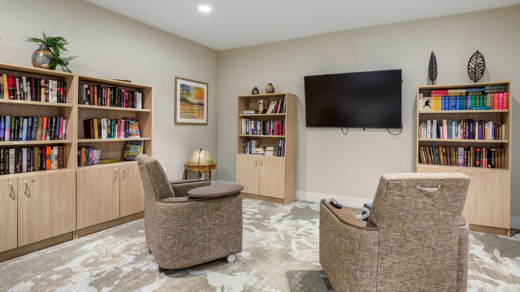 A warm reading nook with inviting chairs, bookshelves, and a serene atmosphere for community gatherings.