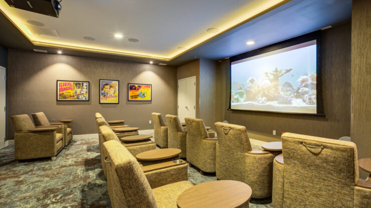 A welcoming theater space with comfortable seating, inviting residents to enjoy films together.