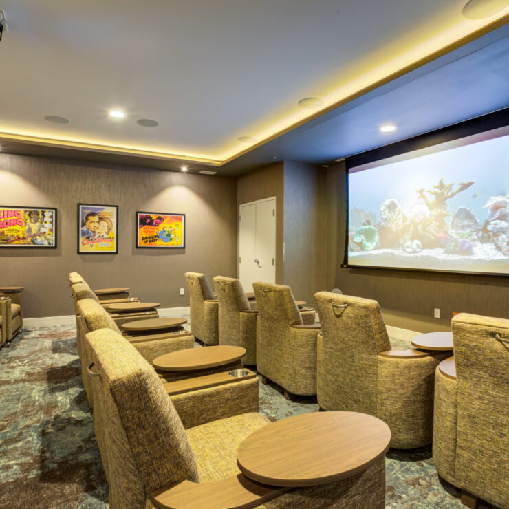 A welcoming theater space with comfortable seating, inviting residents to enjoy films together.