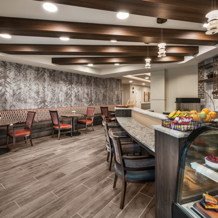 A welcoming café space featuring comfortable seating and a vibrant array of fresh fruits, fostering community and connection.