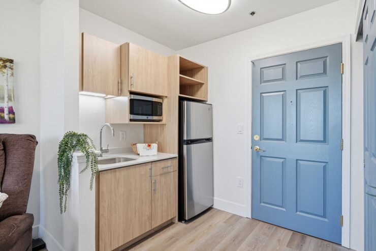 A welcoming kitchenette with modern amenities, inviting warmth and community spirit for residents.