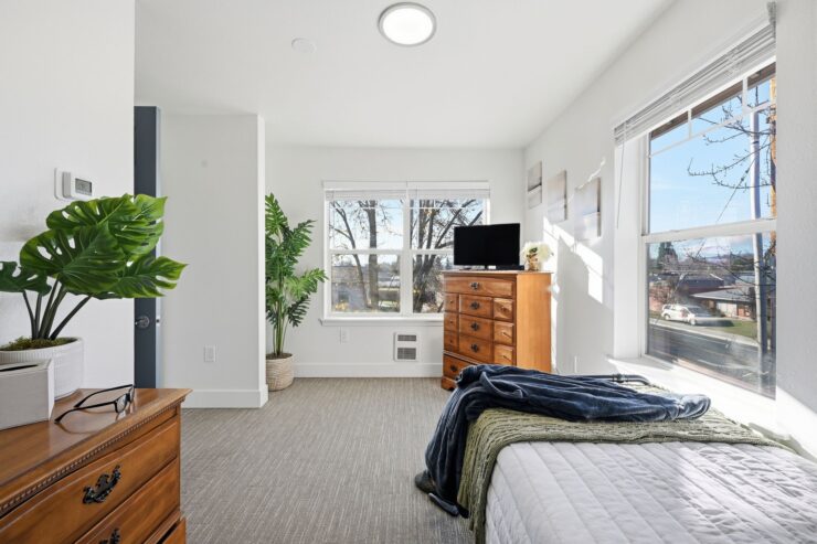 Bright and inviting, this room features comfortable furnishings and a serene view, fostering community and warmth.