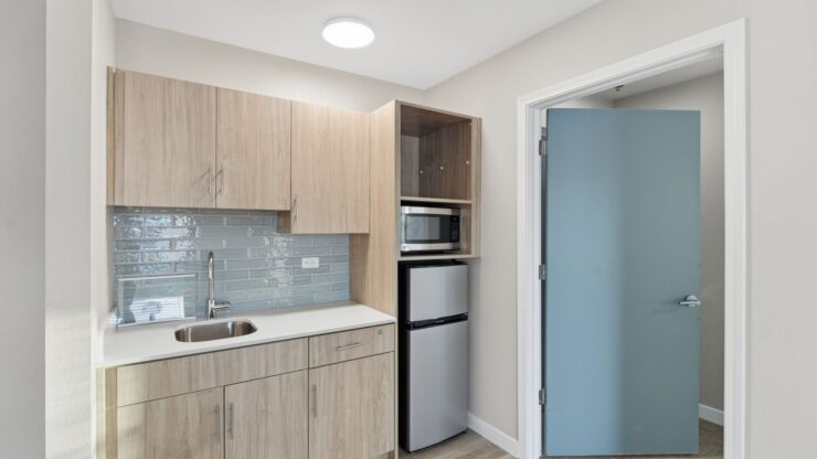 A welcoming kitchenette features modern amenities, fostering comfort and community spirit.