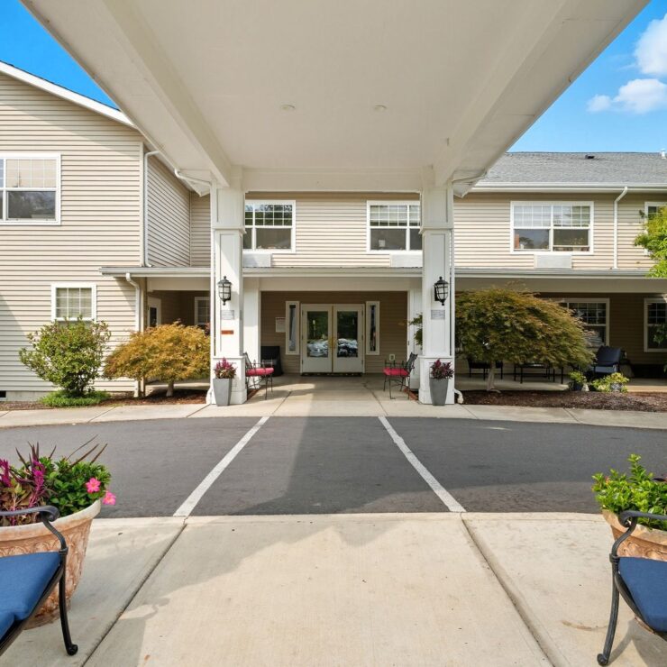 Welcoming entryway with vibrant flowers and comfortable seating, inviting a sense of community and warmth.