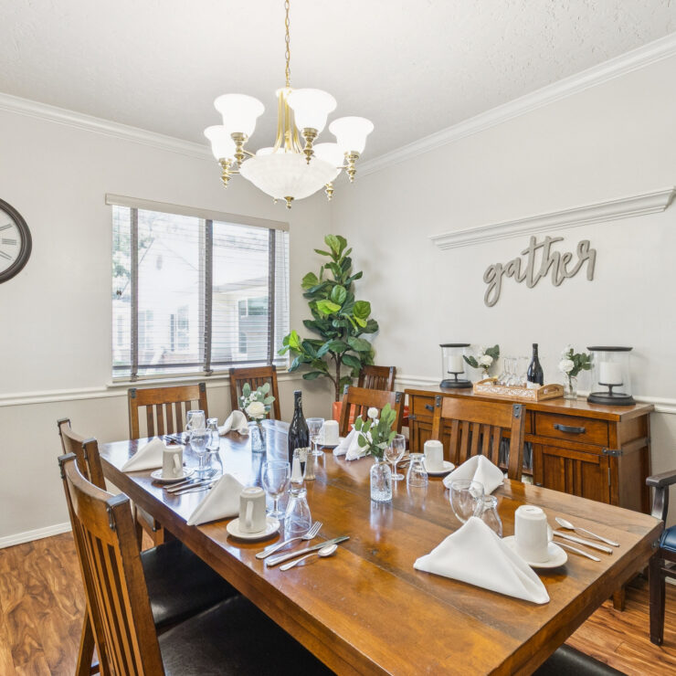 A welcoming dining area featuring a beautifully set table, inviting community gatherings and shared meals.