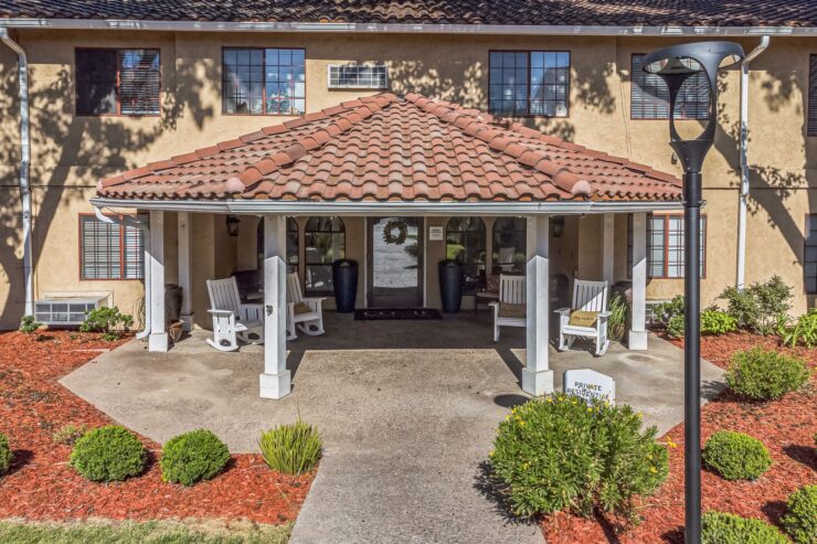 A welcoming entryway featuring comfortable seating, vibrant landscaping, and a friendly atmosphere.