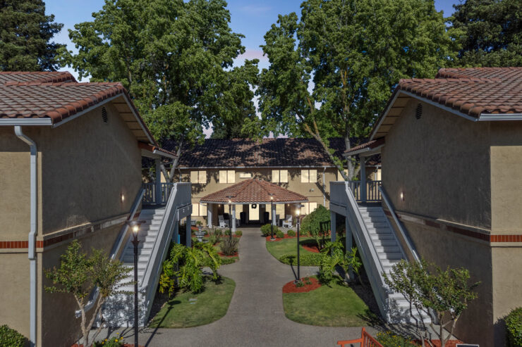 A welcoming courtyard surrounded by lush greenery, inviting residents to relax and connect.