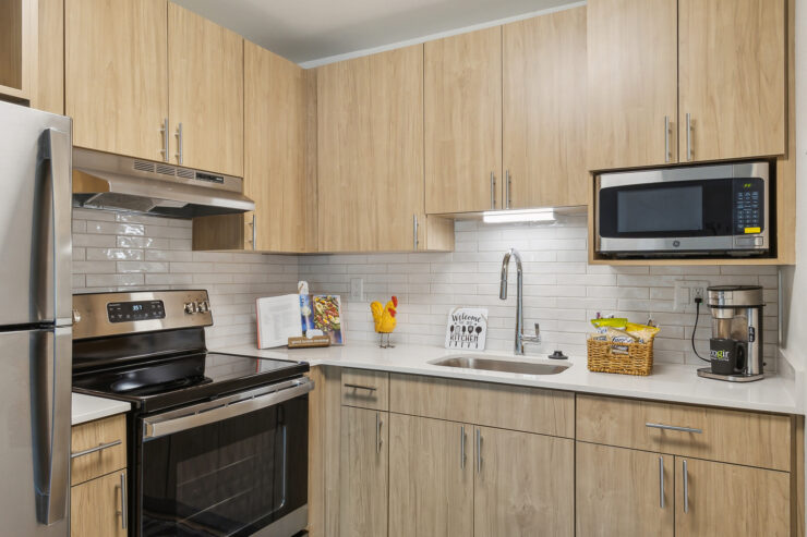 A welcoming kitchen featuring modern appliances, warm wood finishes, and cheerful decor, perfect for community gatherings.