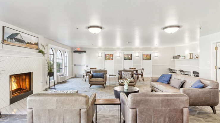 A warm gathering space featuring comfortable seating, a inviting fireplace, and a welcoming atmosphere for community connection.