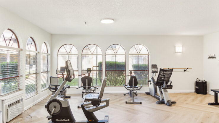 Bright, airy fitness space with modern equipment and large windows, fostering community and wellness.