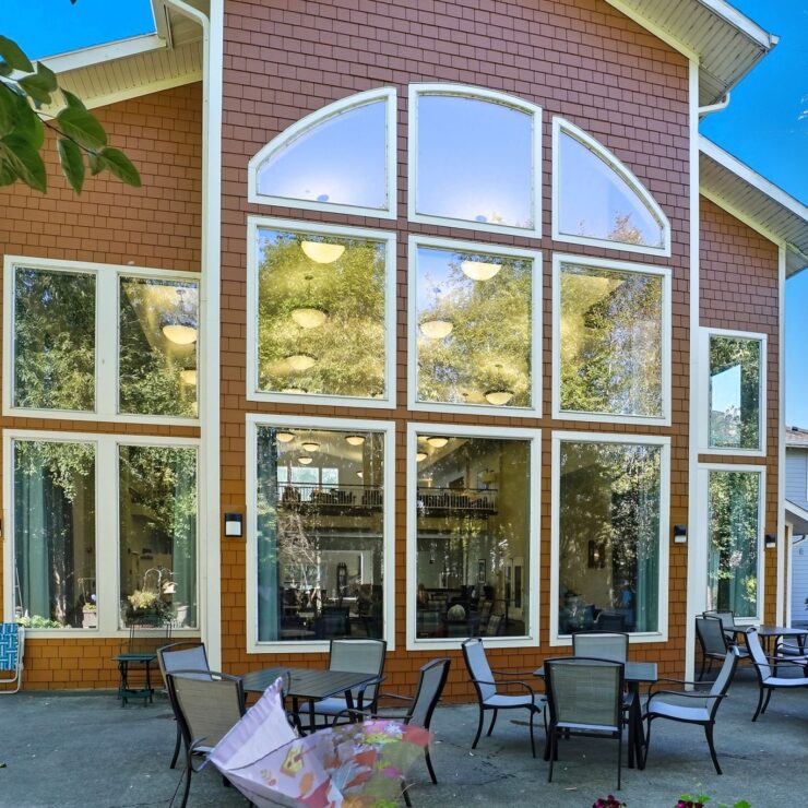 A welcoming community space with large windows, inviting outdoor seating, and a serene atmosphere.