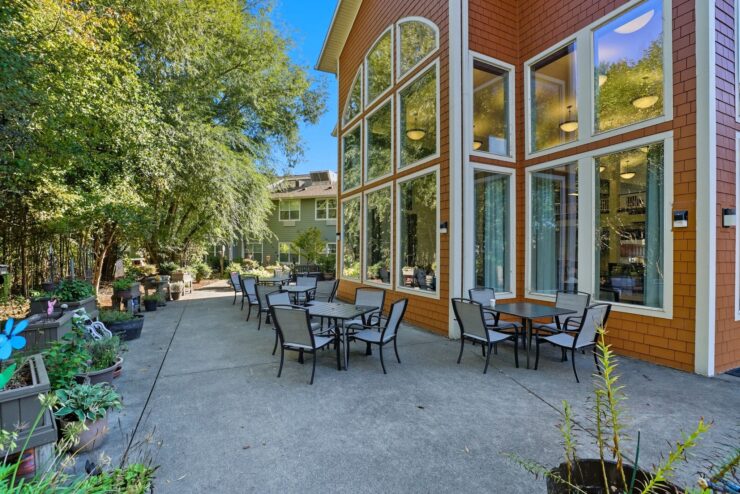 A welcoming outdoor space with seating invites relaxation among lush greenery, fostering community connections.
