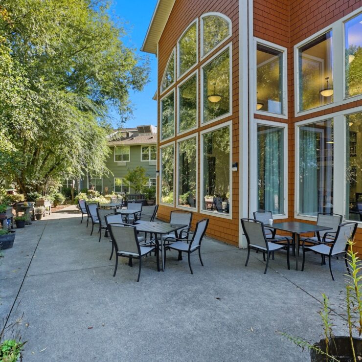 A welcoming outdoor space with seating invites relaxation among lush greenery, fostering community connections.