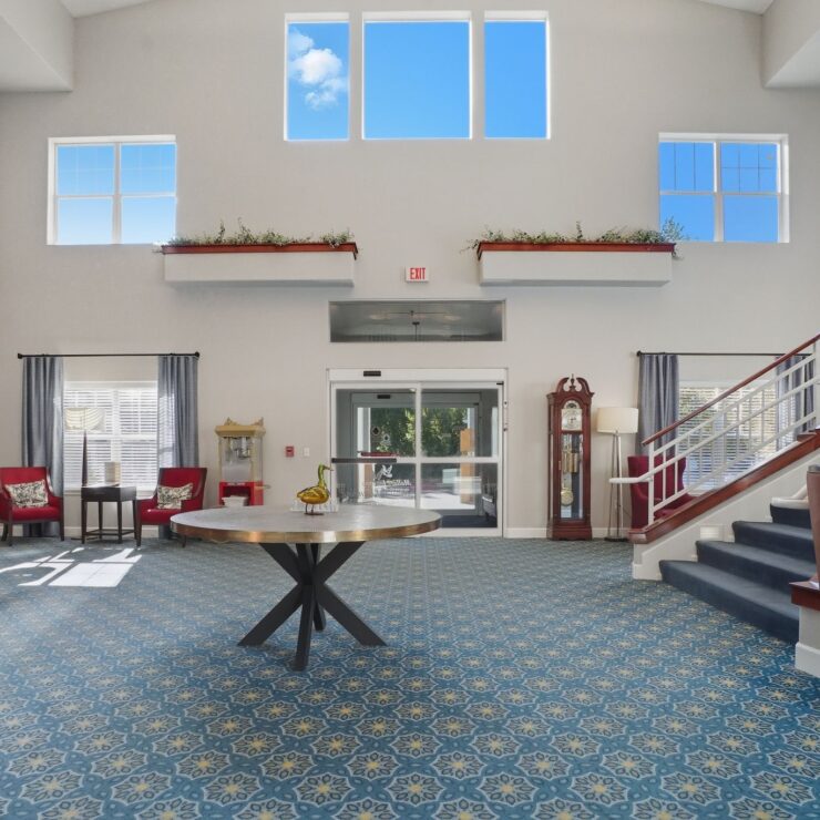 Bright and inviting entryway, featuring comfortable seating and warm decor, fostering a sense of community.