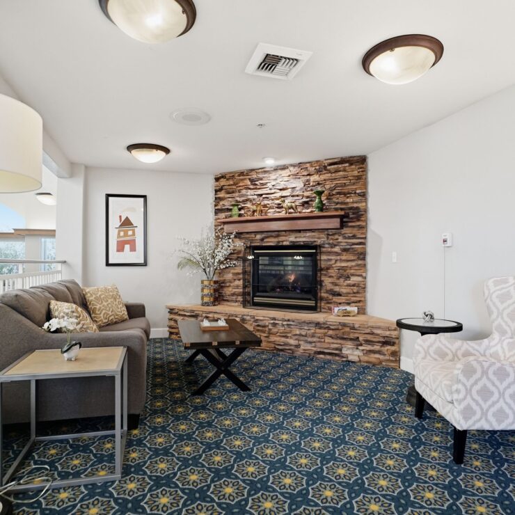A welcoming lounge with a fireplace and comfortable seating, perfect for community gatherings.