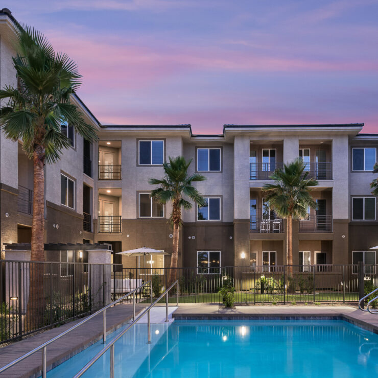 A serene poolside setting surrounded by welcoming residences, perfect for community relaxation and connection.