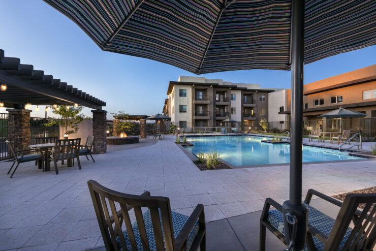 A serene poolside setting invites relaxation and community, perfect for enjoying warm evenings together.