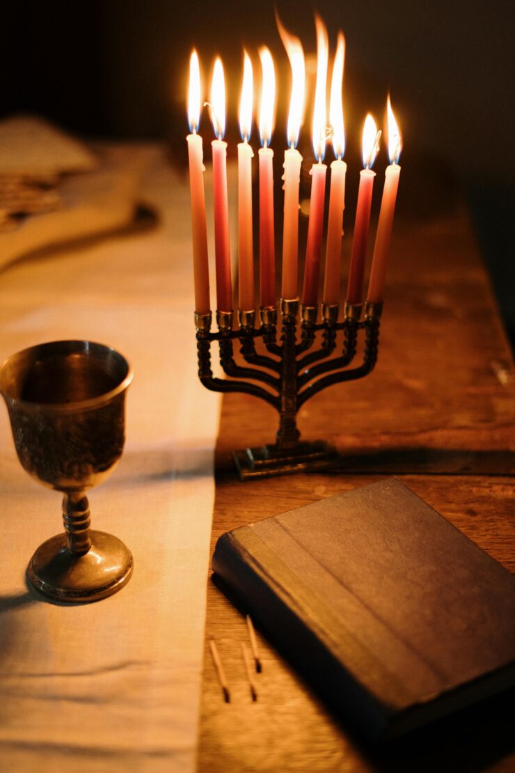 A warm, inviting table setting with flickering candles, a chalice, and an open book, fostering connection.