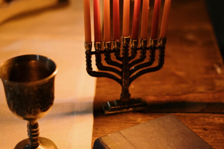 A warm, inviting table setting with flickering candles, a chalice, and an open book, fostering connection.