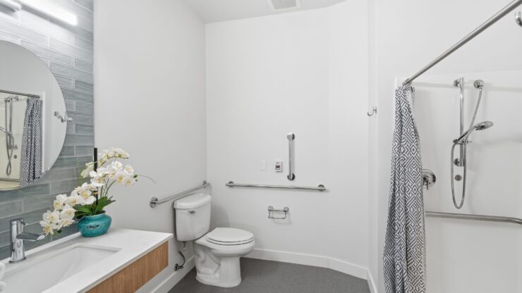 Bright and inviting, this bathroom features modern amenities and thoughtful design for comfort and safety.