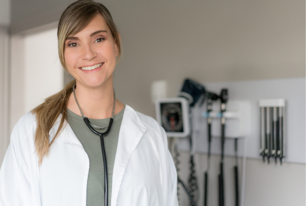 A welcoming healthcare professional smiles in a bright, well-equipped room, fostering a sense of community and care.