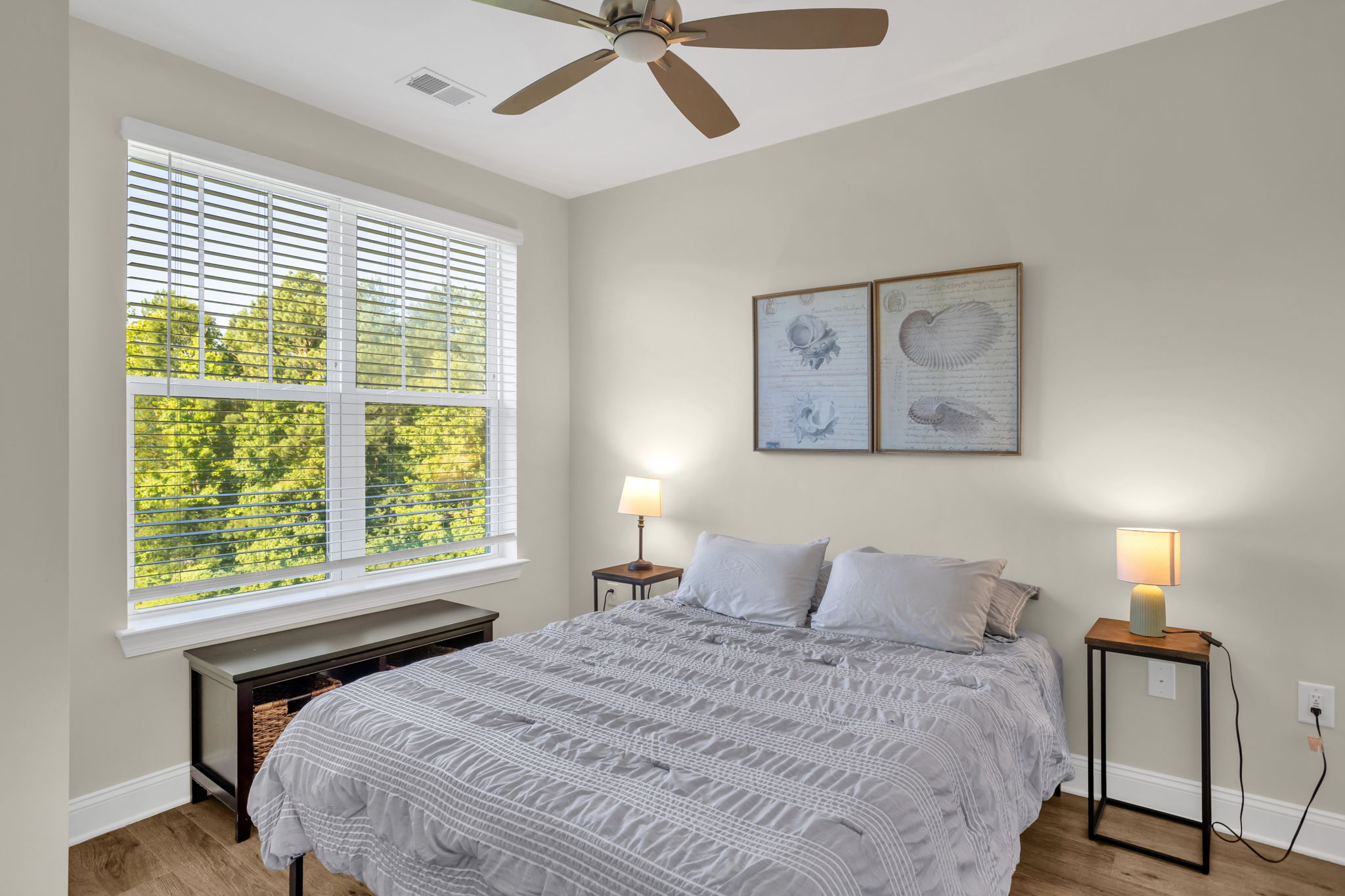 Bright bedroom with natural light, calming decor, and comfortable accommodations for residents.