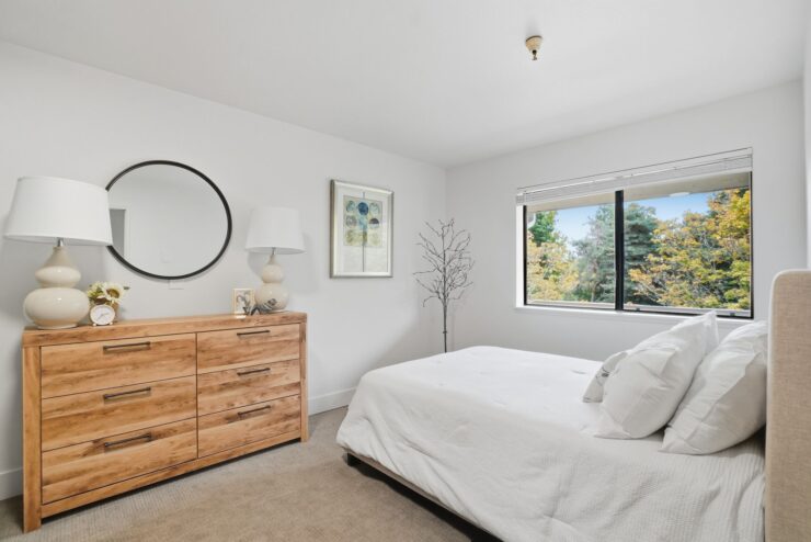Bright and inviting, this serene bedroom offers a peaceful retreat with natural light and warmth.