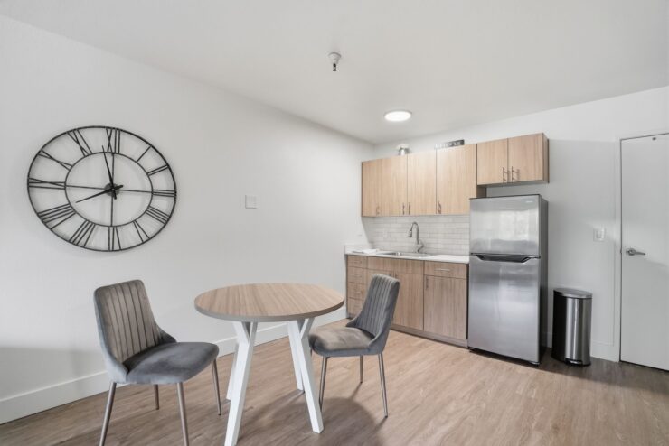 A welcoming dining area features modern furnishings, inviting warmth and community spirit.