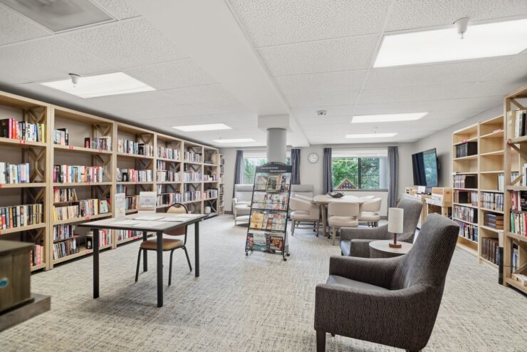 A welcoming library space filled with books, comfortable seating, and natural light, inviting community engagement.