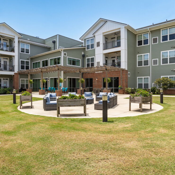 A welcoming outdoor space featuring comfortable seating and lush greenery, perfect for community gatherings.